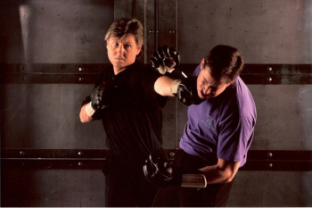 Chris Kent demonstrating a punch with a training partner